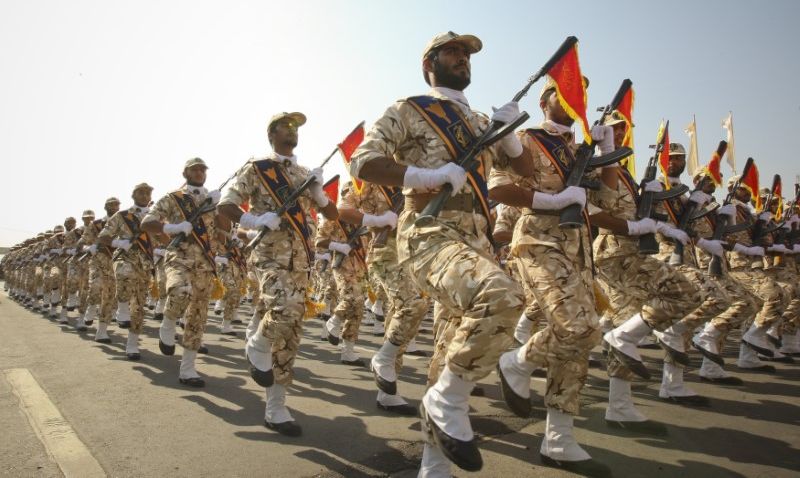 Members of the Iranian revolutionary guard march during a parade to commemorate the anniversary of the Iran-Iraq war, in Tehran