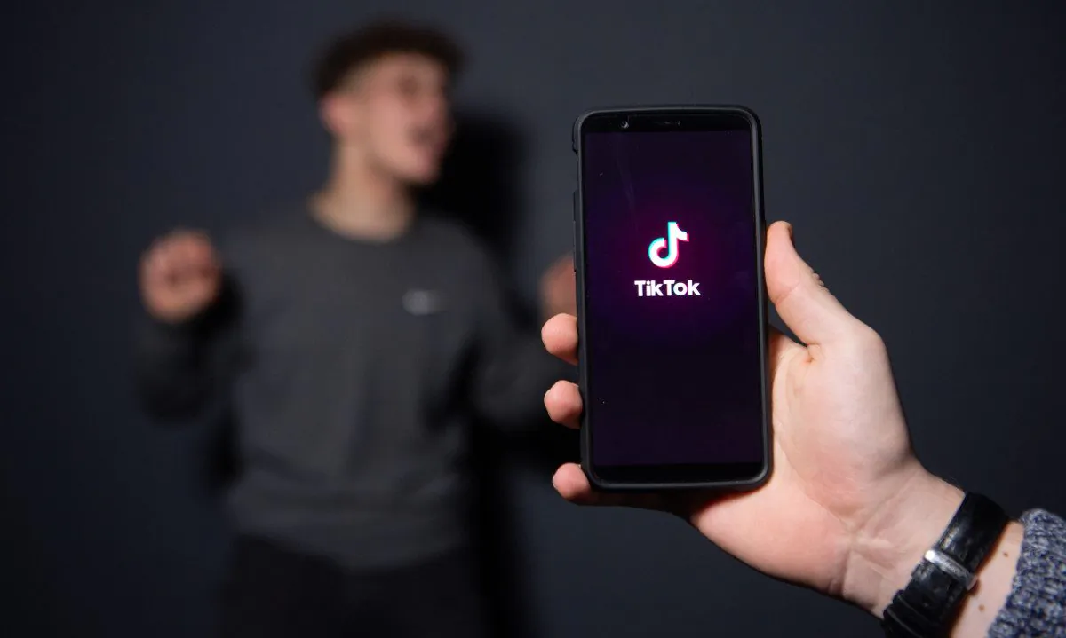 A man posses for a picturing taken by the smartphone app Tiktok. (-/AFP/Getty Images)