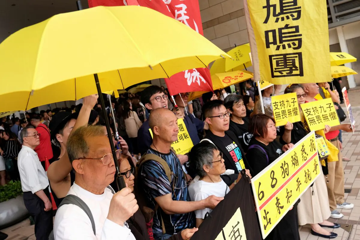Pro-democracy supporters hold yellow umbrella to support leaders of Occupy Central activists, outside the court, in Hong Kong, China on April 9, 2019. (Tyrone Siu/Reuters)