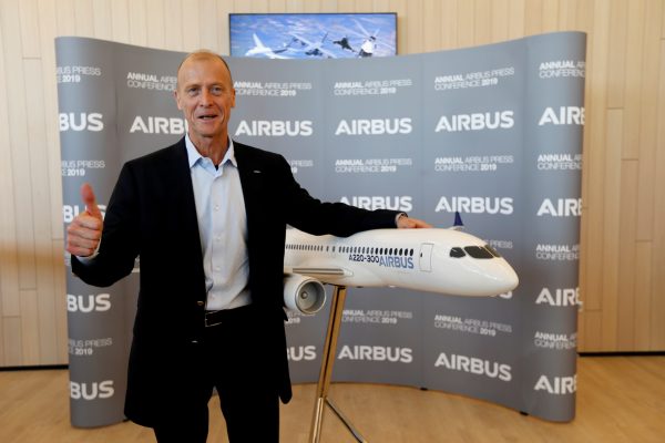 Airbus Chief Executive Tom Enders poses with a A220-300 Airbus replica