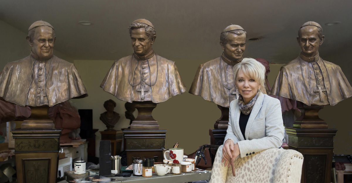 Carolyn D. Palmer with her sculptures of  four popes. (Erik Christian)