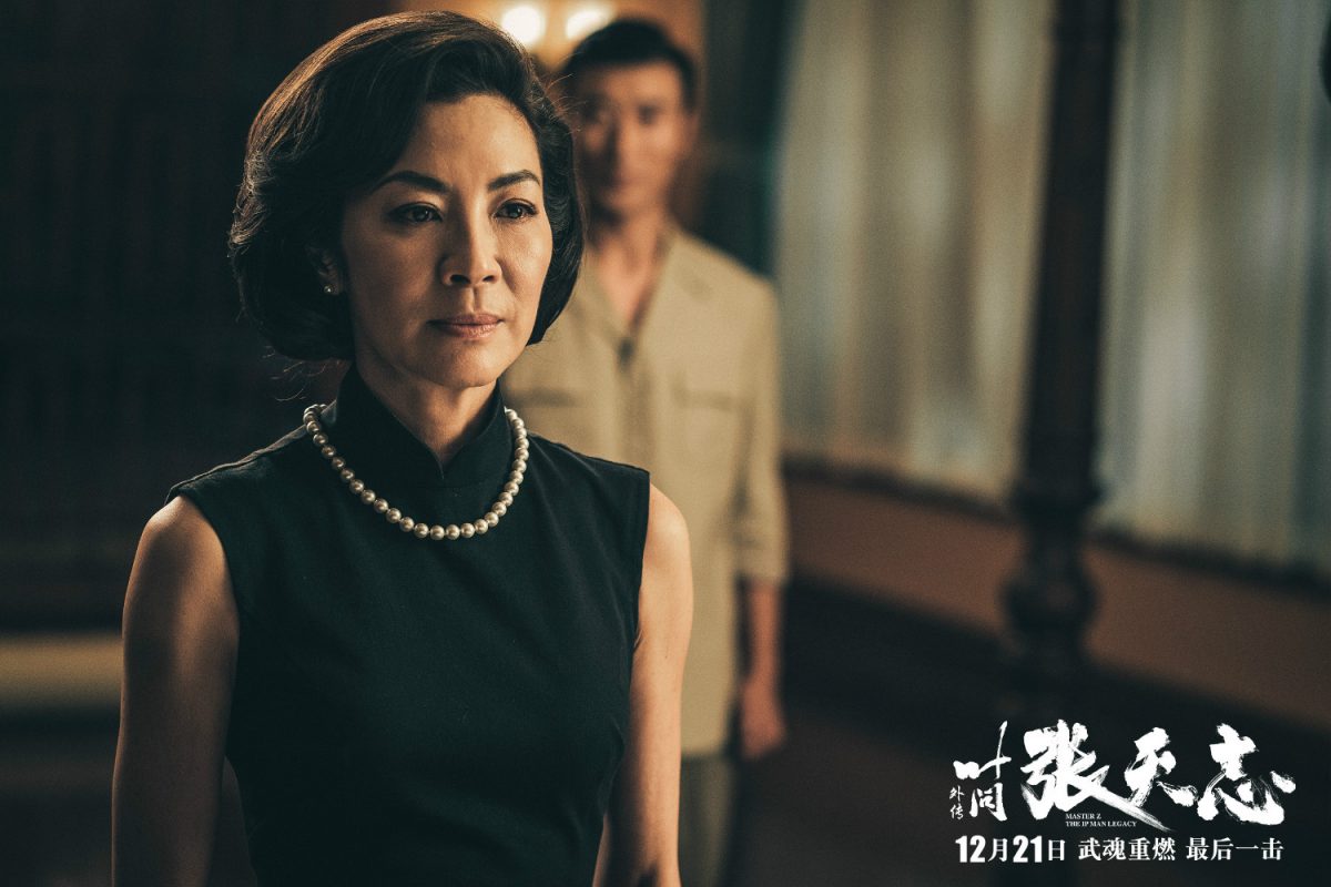 woman in black dress with pearls