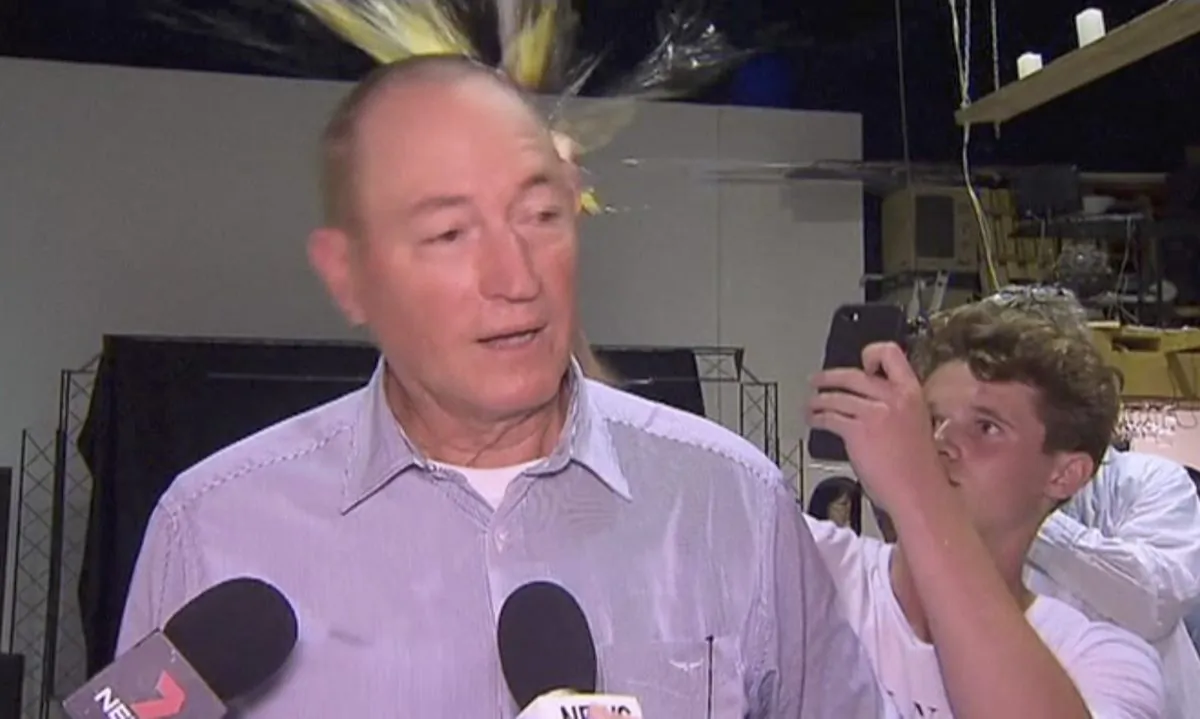 A teenager breaks an egg on the head of Senator Fraser Anning while he holds a press conference, in Melbourne on March 16, 2019. (AP Photo/File)