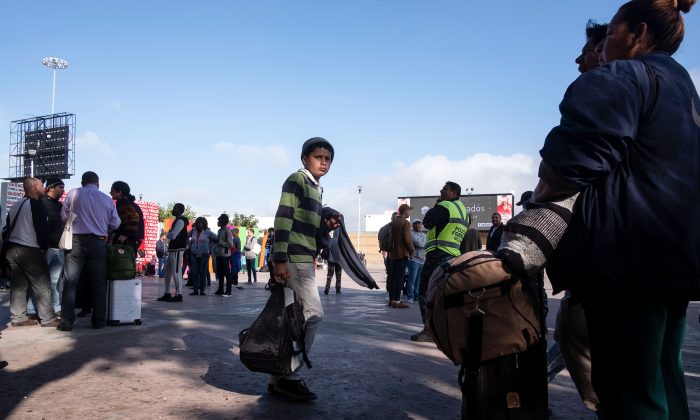 Asylum seekers wait for their turn to request asylum to US authorities outside El Chaparral port of entry in Tijuana, Baja California state, Mexico, on April 9, 2019. (Guillermo Arias/AFP/Getty Images)