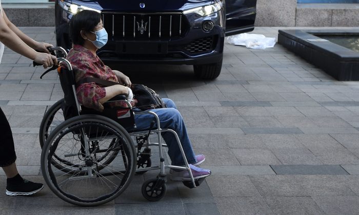 A woman pushed in her wheelchair in China. (WANG ZHAO/AFP/Getty Images)