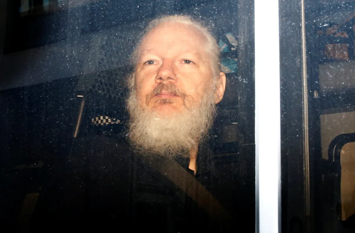 WikiLeaks founder Julian Assange is seen in a police van, after he was arrested by British police, in London, Britain, on April 11, 2019. (Henry Nicholls/Reuters)
