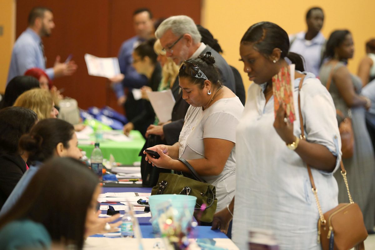 People attend a job fair put on by Miami-Dade County and other sponsors in Miami