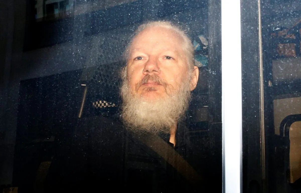 WikiLeaks founder Julian Assange in a police van, after he was arrested by British police, in London on April 11, 2019. (Henry Nicholls/Reuters)