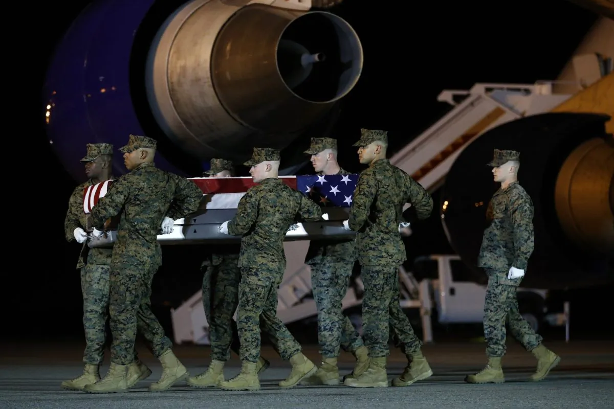 A U.S. Marine Corps carry team moves a transfer case containing the remains of Staff Sgt. Christopher Slutman at Dover Air Force Base, Del., on April 11, 2019. (Patrick Semansky via AP)