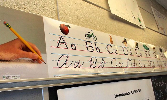 A poster showing third-grade pupils how to write in printed and cursive letters runs across the top of a blackboard at Triadelphia Ridge Elementary School in Ellicott City, Maryland on October 15, 2013. (Robert MacPherson/AFP/Getty Images)