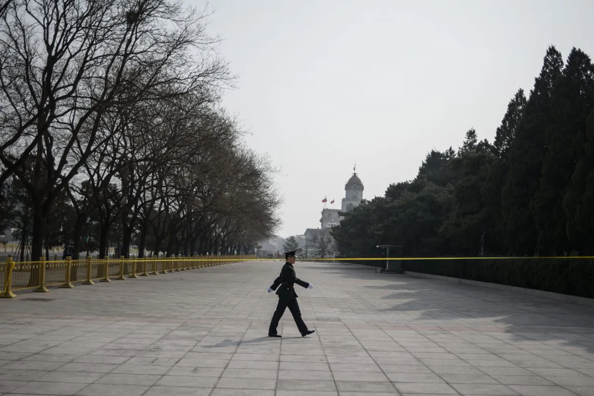 A Chinese soldier walks in front of the Great Hall of the People on the eve of the opening session of the Chinese People's Political Consultative Conference in Beijing on March 2, 2019. FRED DUFOUR / AFP