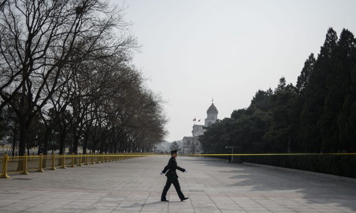 A Chinese soldier walks in front of the Great Hall of the People on the eve of the opening session of the Chinese People's Political Consultative Conference in Beijing on March 2, 2019. FRED DUFOUR / AFP