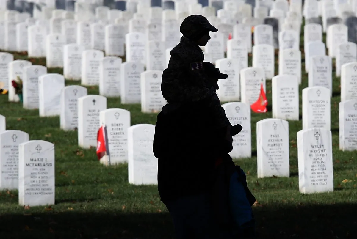 A young boy rides on his father's shoulders while visiting Arlington National Cemetery on Veterans Day Nov. 11, 2017 in Arlington, Virginia. (Win McNamee/Getty Images)