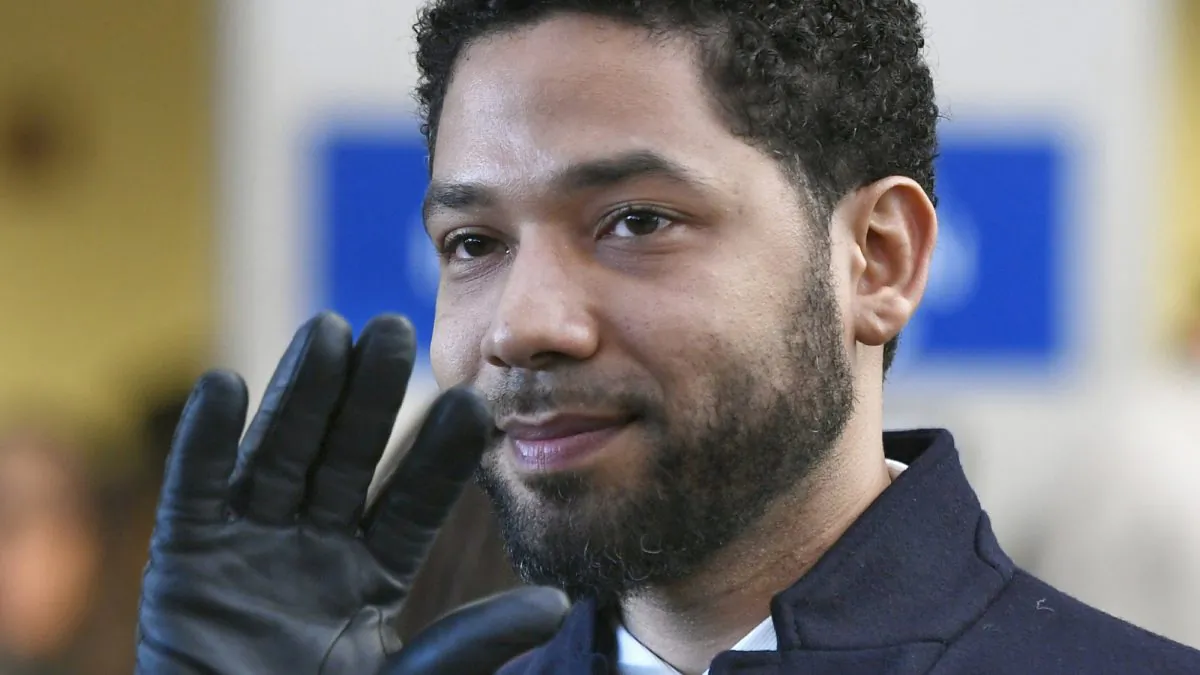 Actor Jussie Smollett smiles and waves to supporters before leaving Cook County Court after his charges were dropped in Chicago. A deadline is looming for Smollett to pay over $130,000 to Chicago to cover part of the costs of an investigation into his report of a racist, anti-gay attack or risk getting slapped with a civil lawsuit. (Paul Beaty/File/AP Photo)