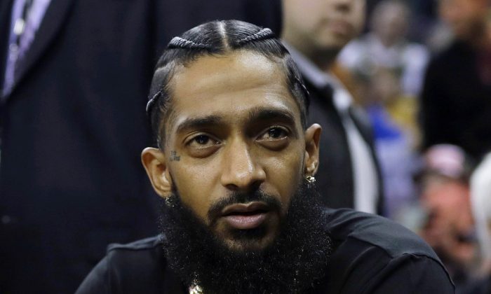 File photo showing late Rapper Nipsey Hussle at an NBA basketball game in Oakland, Calif., on March 29, 2018. (AP Photo/Marcio Jose Sanchez)
