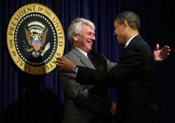 President Barack Obama (R) greets White House counsel Gregory Craig during an event at the Eisenhower Executive Office Building of the White House