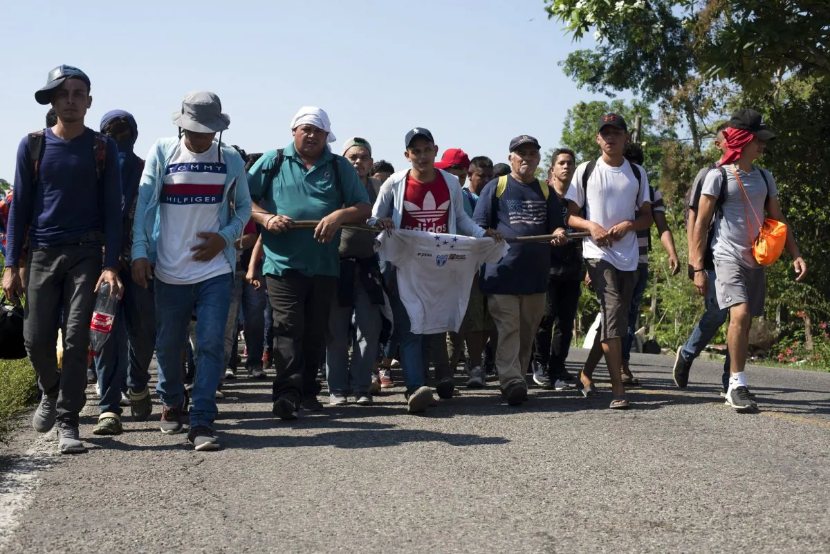 Central American migrants, part of a caravan hoping to reach the United States border, walk on a road in Frontera Hidalgo, Mexico, on April 12, 2019. (Isabel Mateos/Photo via AP)