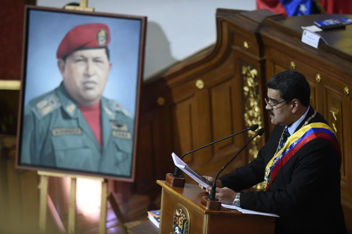Venezuelan President Nicolas Maduro speaks before the Constituent Assembly near a portrait of late Venezuelan President Hugo Chavez to announce measures to alleviate the serious economic crisis, at the Federal Legislative Palace in Caracas on Jan. 14, 2019. (FEDERICO PARRA/AFP/Getty Images)