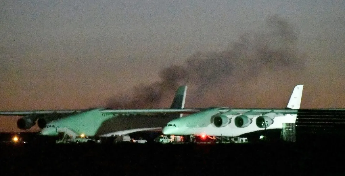 Heavy black smoke rises from one of the six engines starting, before the first test flight of the world's largest airplane, built by the late Paul Allen's company Stratolaunch Systems, in Mojave, Calif. on April 13, 2019. (REUTERS/Gene Blevins)