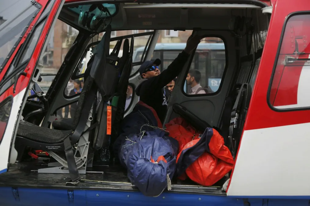 Hospital officials get ready to unload from a helicopter the bodies of plane crash victims outside the Teaching Hospital in Kathmandu, Nepal, on April 14, 2019. (Niranjan Shrestha/AP Photo)
