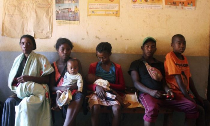 In this photo taken Thursday, March 21, 2019, mothers wait to have their babies vaccinated against measles, at a healthcare center in Larintsena, Madagascar (AP Photo/Laetitia Bezain)