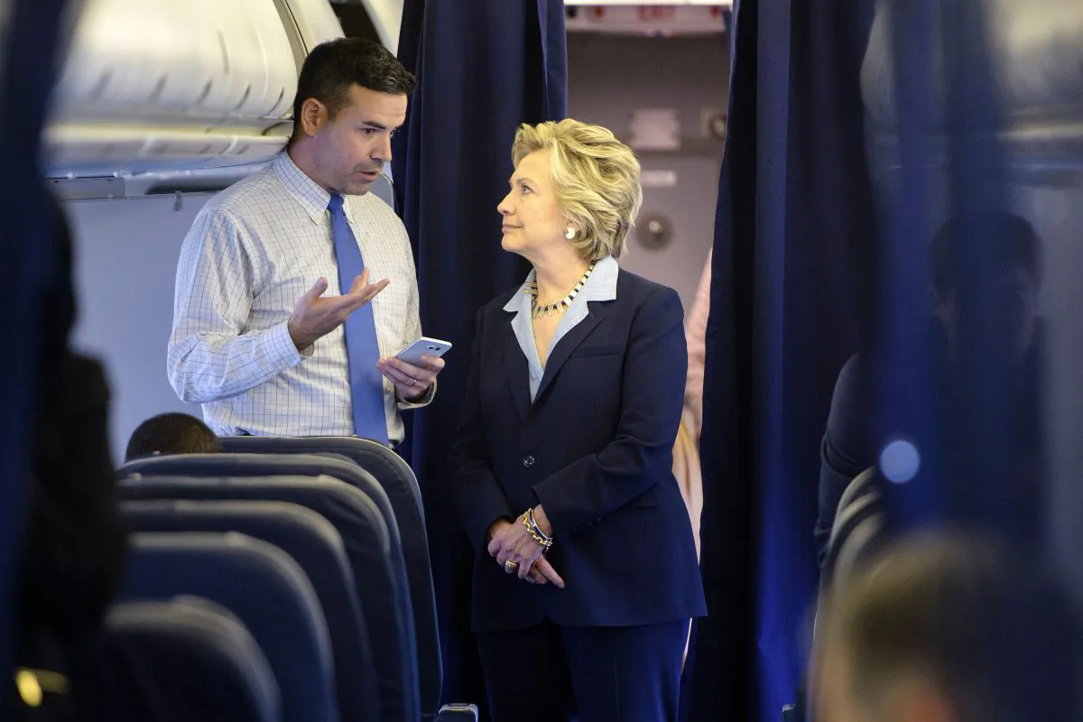 Democratic presidential nominee Hillary Clinton and national press secretary Brian Fallon on  her plane at Westchester County Airport in White Plains, N.Y., on Oct. 3, 2016. (BRENDAN SMIALOWSKI/AFP/Getty Images)