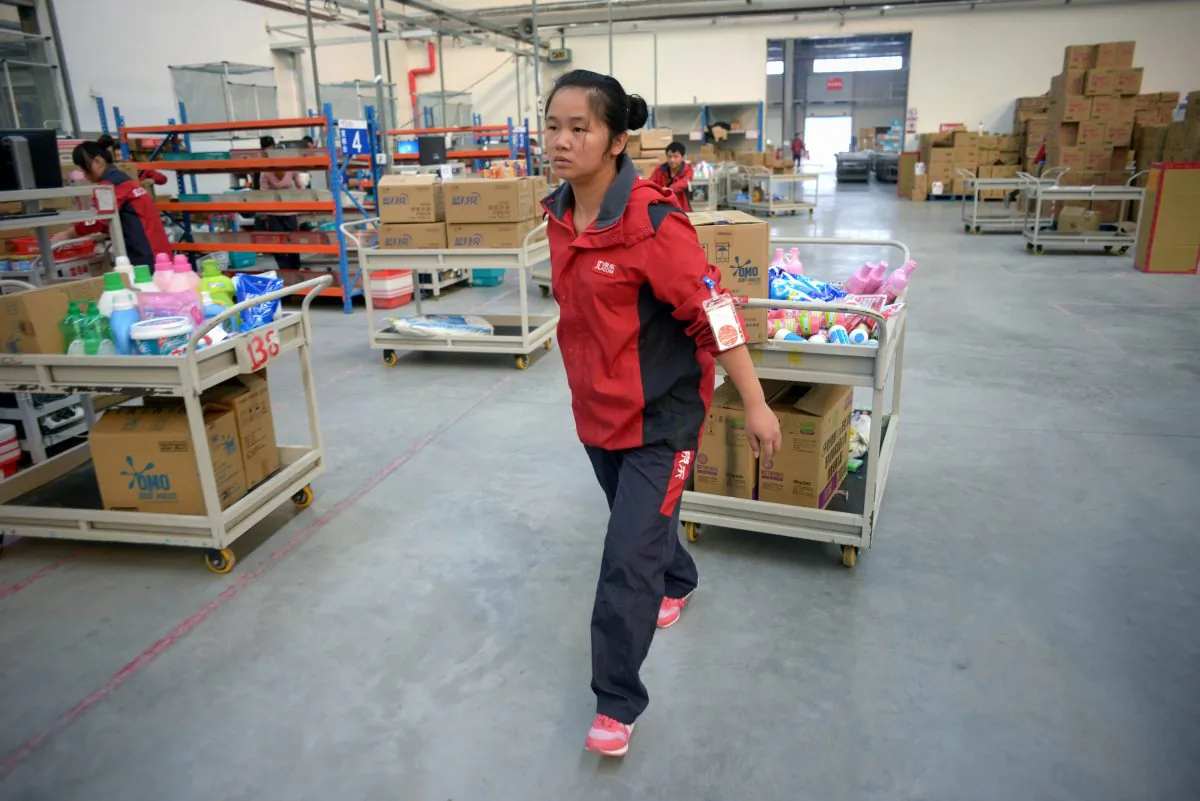 A worker of online marketplace JD.com pushing a trolley at the company's warehouse in Langfang, Hebei province on November 3, 2015. (WANG ZHAO/AFP/Getty Images)