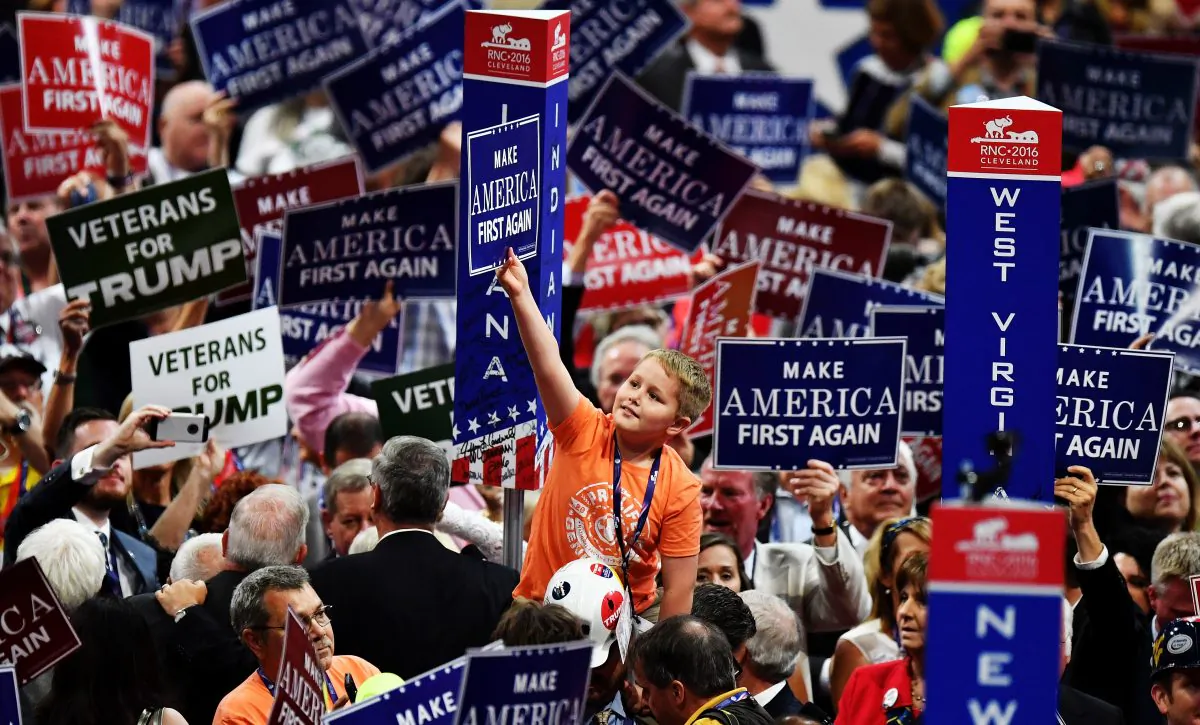 Delegates hold up signs that read "Make America First Again" at the Republican National Convention at the Quicken Loans Arena in Cleveland, Ohio, on July 20, 2016. Jeff J Mitchell/Getty Images