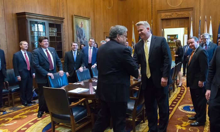 Attorney General William Barr shakes hands with U.S. Attorney John Huber at the Justice Department in Washington, D.C., in March, 2019. (Courtesy Justice Department)