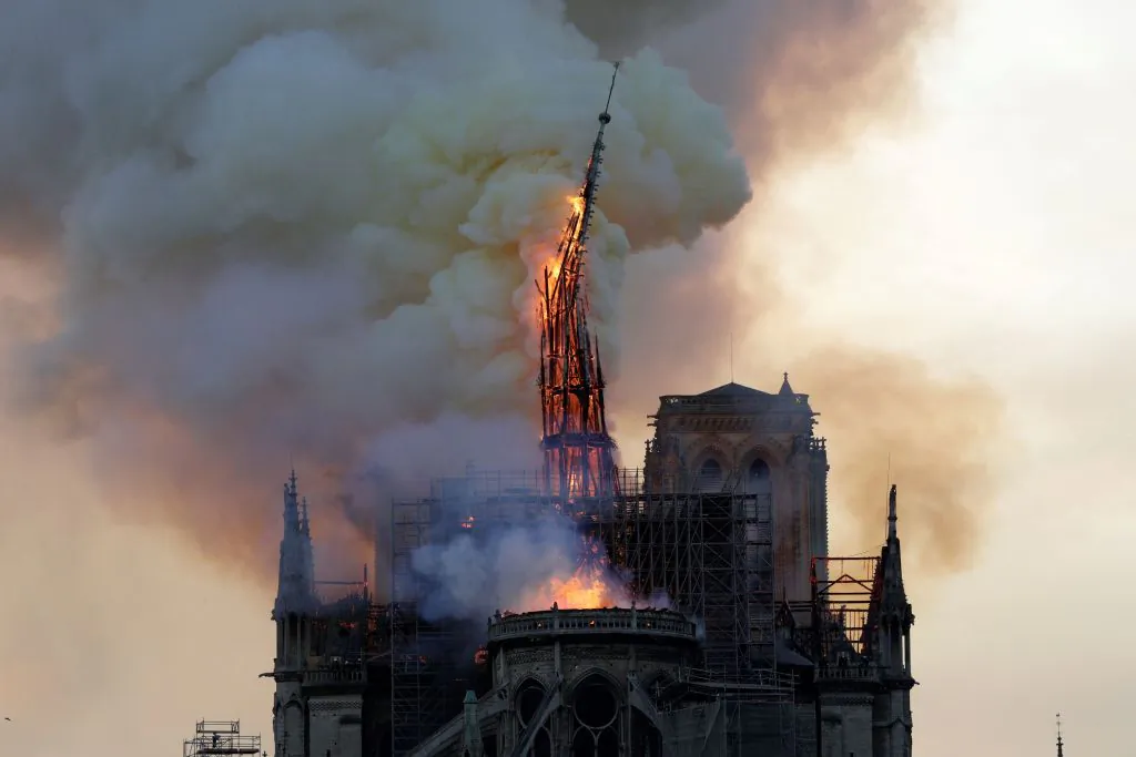 The steeple of the landmark Notre-Dame Cathedral collapses as the cathedral is engulfed in flames in central Paris on April 15, 2019. (Geoffroy Van Der Hasselt/AFP/Getty Images)