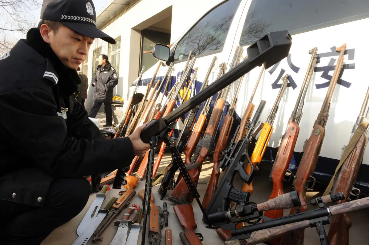 Chinese police prepare to destroy some 900 firearms and ammunition seized over the last nine months in Beijing on December 16, 2010. (STR/AFP/Getty Images)