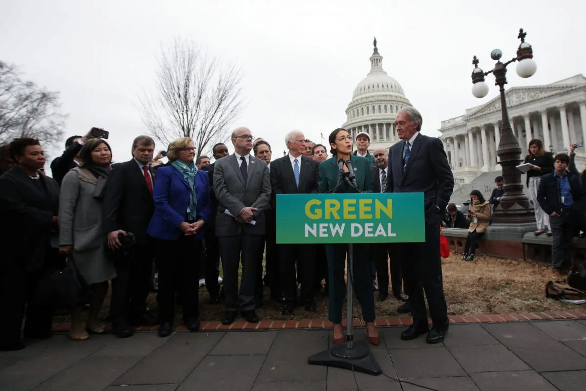 Rep. Alexandria Ocasio-Cortez (D-N.Y.) speaks as Sen. Ed Markey (D-Mass.) (R) and other Congressional Democrats listen during a news conference in front of the U.S. Capitol in Washington, Feb. 7, 2019. (Alex Wong/Getty Images)