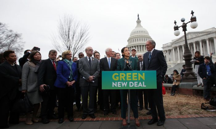 Rep. Alexandria Ocasio-Cortez (D-N.Y.) speaks as Sen. Ed Markey (D-Mass.) (R) and other Congressional Democrats listen during a news conference in front of the U.S. Capitol in Washington, Feb. 7, 2019. (Alex Wong/Getty Images)