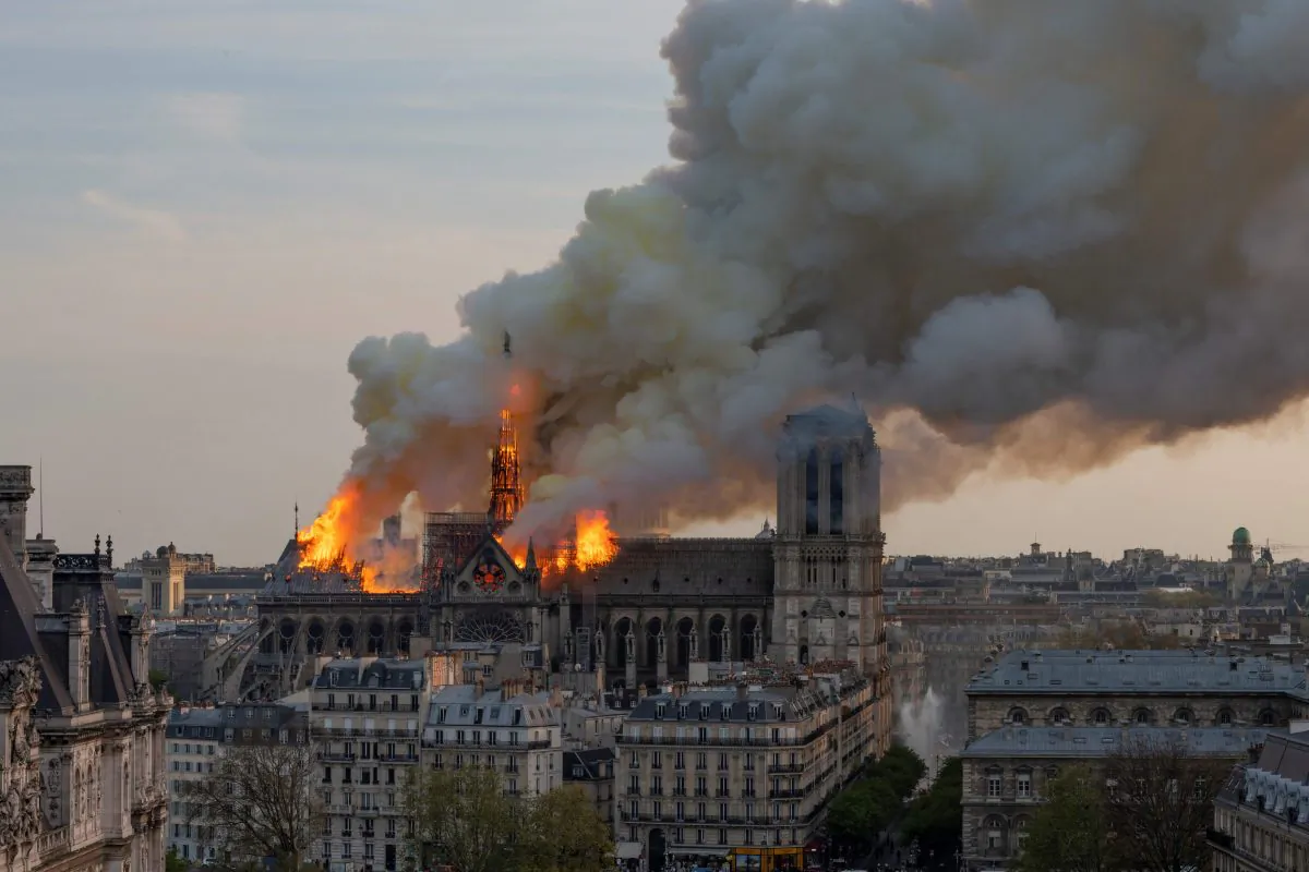 Smoke billows as flames burn through the roof of the Notre-Dame cathedral  in the French capital Paris on April 15, 2019. FABIEN BARRAU/AFP/Getty Images
