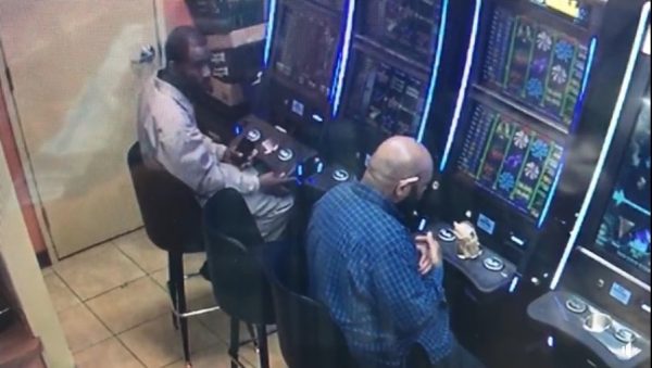 suspect lifts panel on machine