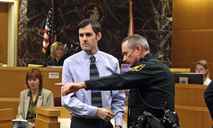 Defendant John Jonchuck is directed by a Pinellas County Sheriff deputy to the finger print area after a jury found him guilty, Tuesday, April 16, 2019, Clearwater, Fla. (Scott Keeler/Tampa Bay Times/AP)