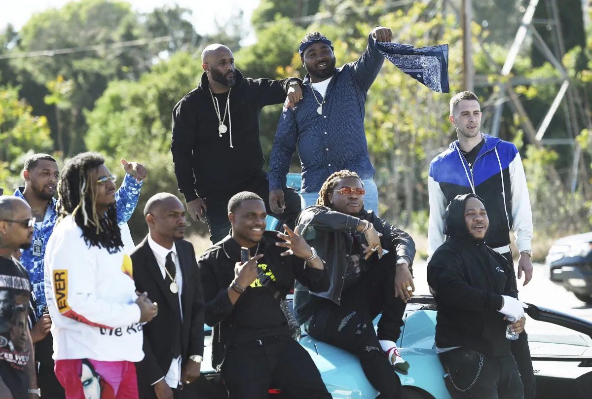 Friends and family attend the burial of late Rapper Nipsey Hussle at Forest Lawn Hollywood Hills Cemetery in Los Angeles, Calif., on April 12, 2019. (Chris Pizzello/Invision/AP)