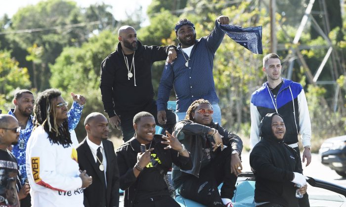 Friends and family attend the burial of late Rapper Nipsey Hussle at Forest Lawn Hollywood Hills Cemetery in Los Angeles, Calif., on April 12, 2019. (Chris Pizzello/Invision/AP)