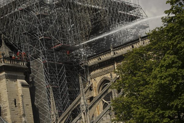 Firefighters work with a hose at the Notre Dame cathedral in Paris