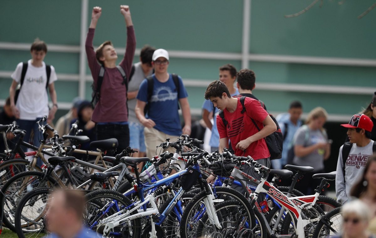 Students leave Columbine High School late in Littleton, Colo.,