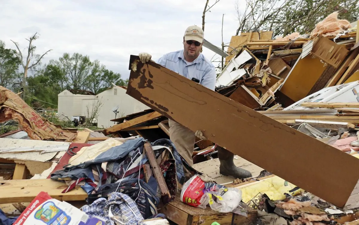 A man clears rubble after the storm at Hamilton, Mississippi, on April 14, 2019. (AP Photo/Jim Lytle)