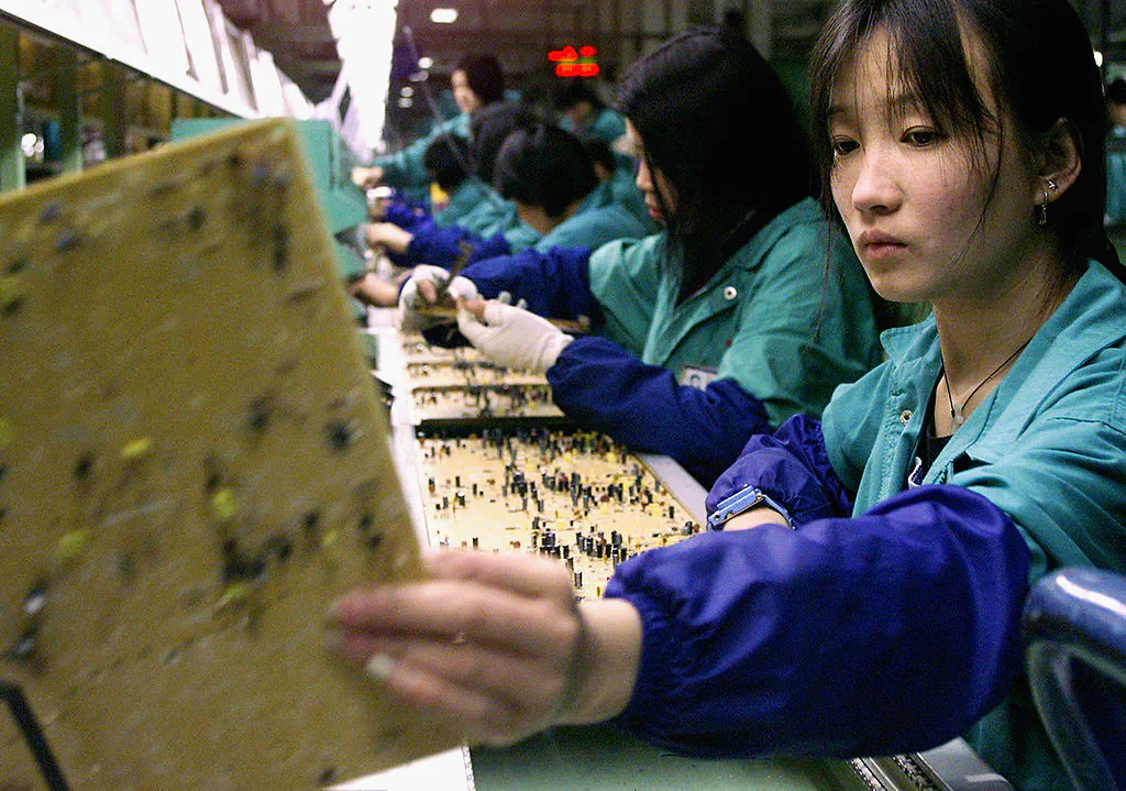 Workers inspect data boards at a Taiwanese factory in China's Fujian province. (STEPHEN SHAVER/AFP/Getty Images)