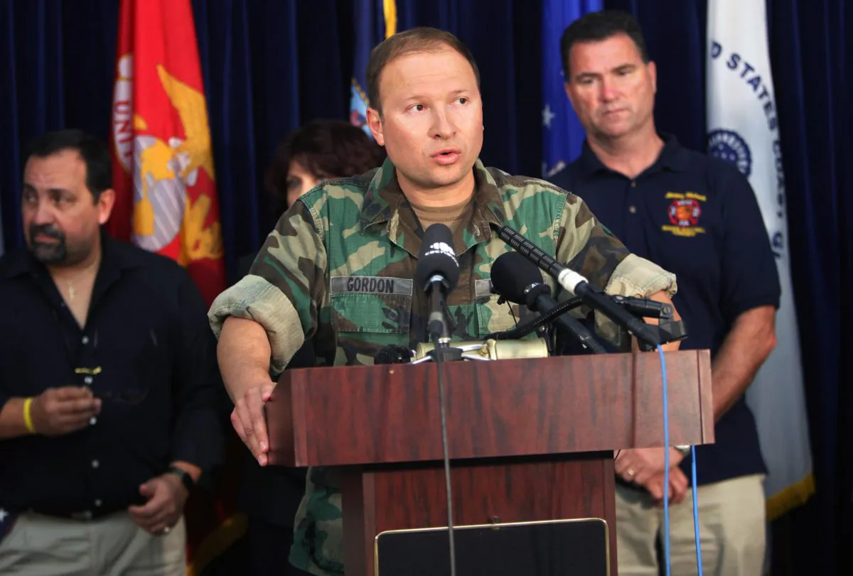 Pentagon spokesman Cmdr. J.D. Gordon introduces family members of victims of the Sept. 11, 2001, terrorist attack, in Guantanamo Bay, Cuba, on Jan. 19, 2009. (BRENNAN LINSLEY/AFP/Getty Images)
