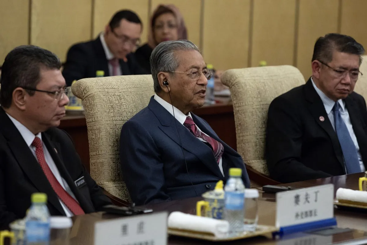 Malaysian Prime Minister Mahathir Mohamad (C) speaks to Chinese President Xi Jinping (not pictured) during their meeting at Diaoyutai State Guesthouse in Beijing on Aug. 20, 2018. (ROMAN PILIPEY/AFP/Getty Images)