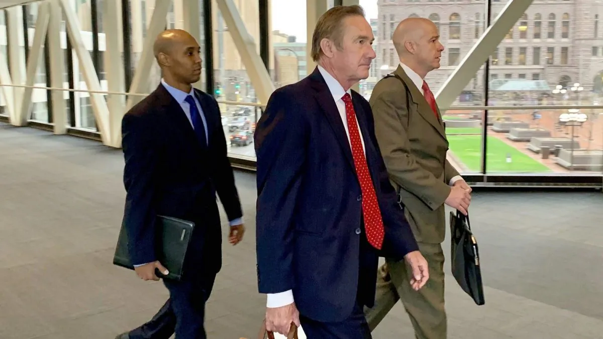 Former Minneapolis police officer Mohamed Noor left, arrived with his defense attorneys Peter Wold, center, and Thomas Plunkett, right, before another day of testimony in Noor's murder and manslaughter trial in Minneapolis on April 17, 2019.  (Jeff Baenen/AP Photo)