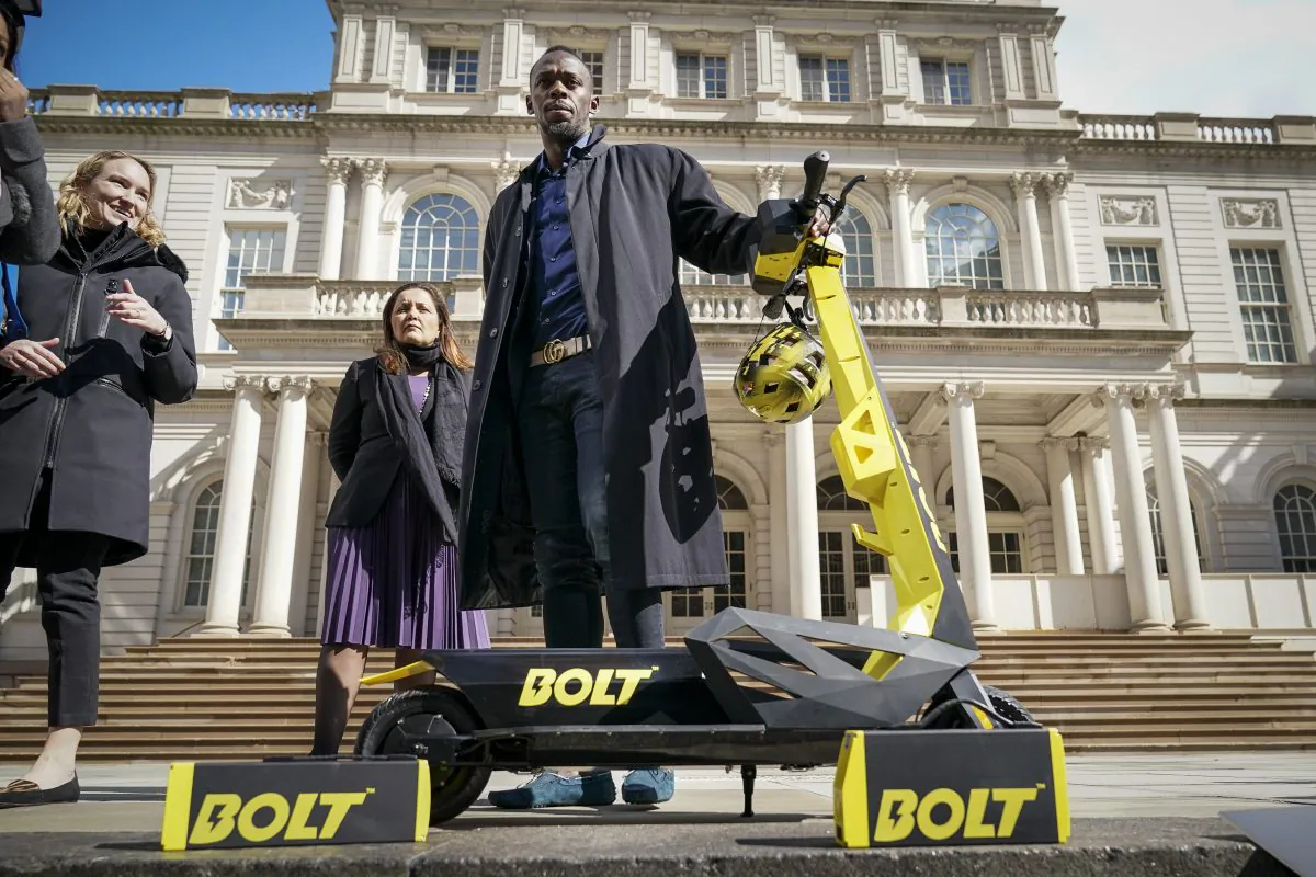Track star and new Bolt pitchman Usain Bolt poses for photos with a Bolt Mobility scooter outside of New York City Hall following a press conference about the new product, Mar. 12, 2019 in New York City. (Drew Angerer/Getty Images)