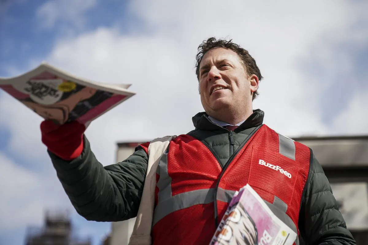 Ben Smith, editor-in-chief of BuzzFeed, hands out free copies of a BuzzFeed newspaper outside the Union Square subway station in New York City on March 6, 2019. (Drew Angerer/Getty Images)