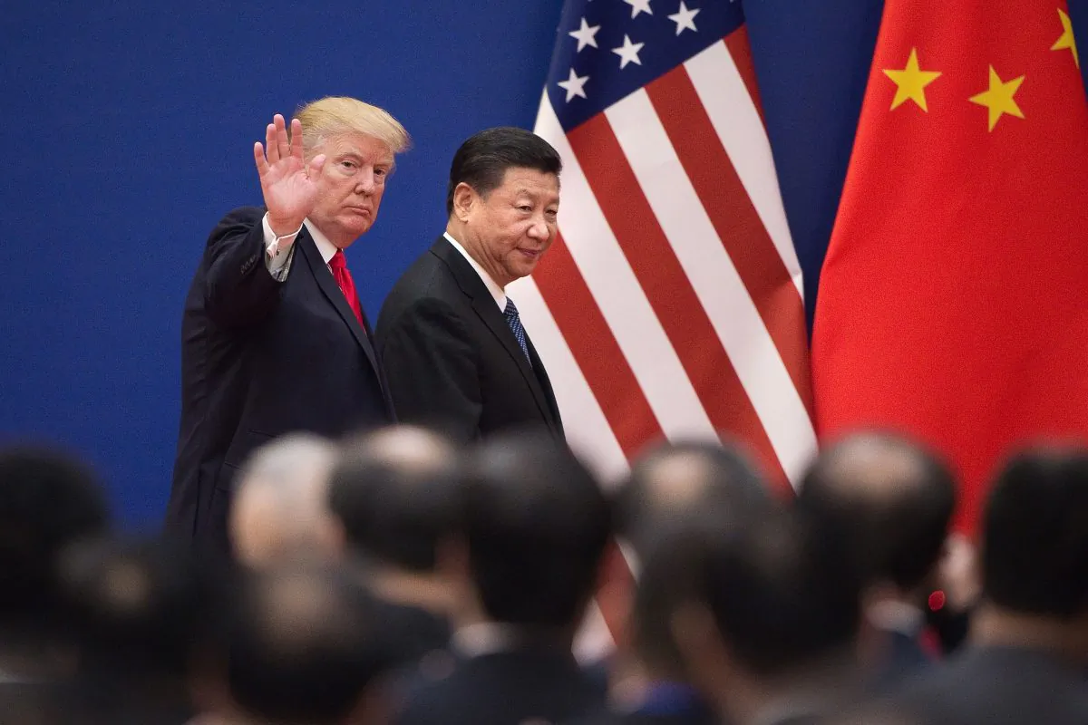 U.S. President Donald Trump (L) and Chinese leader Xi Jinping leave a business leaders event at the Great Hall of the People in Beijing on Nov. 9, 2017. (Nicolas Asfouri/AFP/Getty Images)