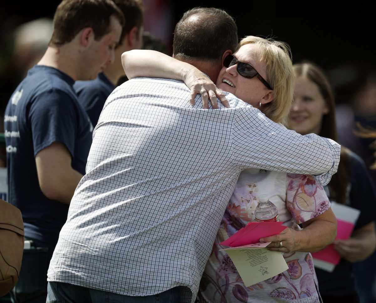 Columbine attendees hug, columbine attendees