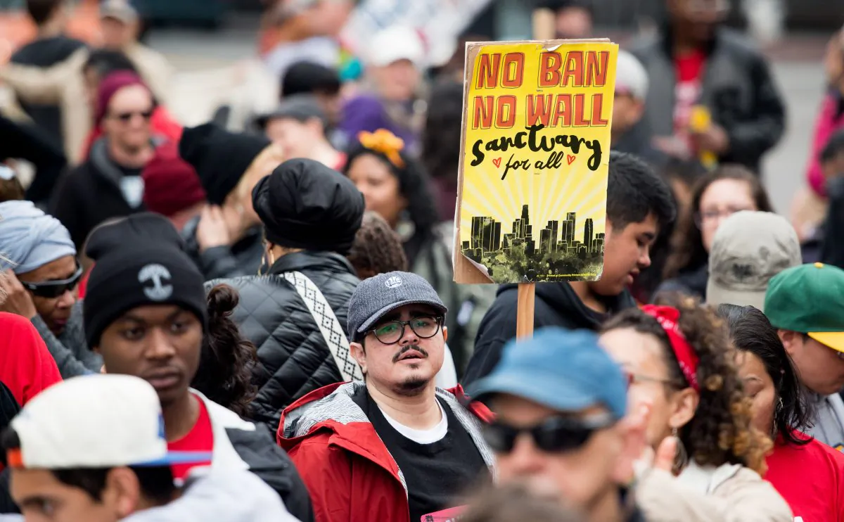 A man carries a sign supporting sanctuary cities during a march in Oakland, Calif., on Jan. 15, 2018. (Josh Edelson/AFP/Getty Images)